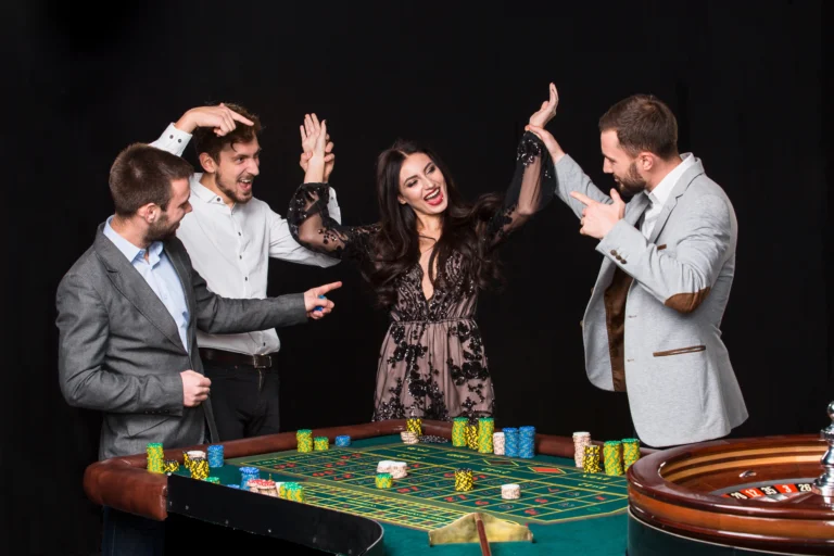 group-young-people-roulette-table-black-background-young-woman-rejoices-victory